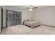 Bedroom includes tile floors, fan, and sliding glass door to exterior view at 18829 N 15Th Pl, Phoenix, AZ 85024