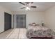 The spacious bedroom offers tile floors, ceiling fan, and sliding glass door to the exterior at 18829 N 15Th Pl, Phoenix, AZ 85024