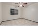 Bedroom view features tile floors, a ceiling fan, and a view of a window looking to the exterior at 18829 N 15Th Pl, Phoenix, AZ 85024