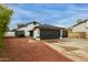 An exterior view of the home with a two car garage and desert landscaping at 18829 N 15Th Pl, Phoenix, AZ 85024