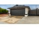View of the home's garage door, driveway and backyard access gate at 18829 N 15Th Pl, Phoenix, AZ 85024