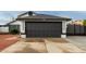 Close up view of the two car garage with a black door and the home's address at 18829 N 15Th Pl, Phoenix, AZ 85024