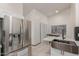 Bright open concept kitchen features stainless steel fridge and a sink with marble countertops and tiled floors at 18829 N 15Th Pl, Phoenix, AZ 85024