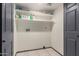Laundry room with built-in shelving and tiled flooring at 18829 N 15Th Pl, Phoenix, AZ 85024