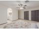 This main bedroom includes a ceiling fan, tile floors, dual closets and archway to bathroom at 18829 N 15Th Pl, Phoenix, AZ 85024