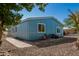 Charming single-story home features a blue exterior, complemented by well-maintained landscaping at 19041 N Pierson Rd, Peoria, AZ 85373