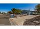 Charming single-story home featuring a carport, desert landscaping and a white picket fence for curb appeal at 19041 N Pierson Rd, Peoria, AZ 85373