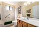 Bright bathroom featuring a shower over tub, single vanity with a large, well lit mirror at 19220 N 93Rd Ave, Peoria, AZ 85382