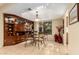 Elegant dining room with a glass table, stylish chairs, and a built-in display cabinet at 19220 N 93Rd Ave, Peoria, AZ 85382