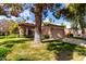 Charming home with a tile roof, mature landscaping, an attached garage, and a manicured front lawn at 19220 N 93Rd Ave, Peoria, AZ 85382