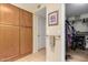 Hallway with built in storage leading to a walk in closet with shelves, racks and drawers for organizing at 19220 N 93Rd Ave, Peoria, AZ 85382