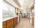 Bright kitchen with tile floors, white appliances, and a breakfast nook near a large window at 19220 N 93Rd Ave, Peoria, AZ 85382
