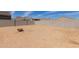 Backyard is enclosed by a block fence, space ready for personalization, with firepit at 19924 W Rancho Dr, Litchfield Park, AZ 85340