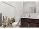 Bathroom features a decorative shower curtain, wood-tone vanity, and neutral color palette at 19924 W Rancho Dr, Litchfield Park, AZ 85340