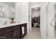 Bathroom features double sinks, dark wood cabinets, and a separate closet and shower room at 19924 W Rancho Dr, Litchfield Park, AZ 85340