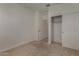 Comfortable bedroom features neutral carpeting, closet with sliding doors, and an open doorway at 19924 W Rancho Dr, Litchfield Park, AZ 85340
