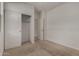 Inviting bedroom showcasing neutral carpet and a closet with convenient sliding doors at 19924 W Rancho Dr, Litchfield Park, AZ 85340