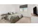 Bright bedroom features a neutral color palette and a large window for natural light at 19924 W Rancho Dr, Litchfield Park, AZ 85340