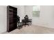 Spare bedroom with neutral carpet features a desk, shelving, and game-oriented chair setup at 19924 W Rancho Dr, Litchfield Park, AZ 85340
