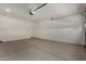 Clean garage features a sealed concrete floor and a side entry door at 19924 W Rancho Dr, Litchfield Park, AZ 85340