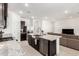 Bright open-concept kitchen featuring an island with seating and stainless steel appliances at 19924 W Rancho Dr, Litchfield Park, AZ 85340