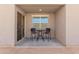 Enclosed patio features tile flooring, a window for added illumination, and seating for two at 19924 W Rancho Dr, Litchfield Park, AZ 85340