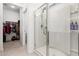 Bathroom shower features a glass door, multi-setting shower head, and built-in storage at 19924 W Rancho Dr, Litchfield Park, AZ 85340