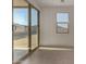 Bright sunroom with large sliding glass doors, tile flooring, and backyard view at 19924 W Rancho Dr, Litchfield Park, AZ 85340