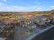 Stunning aerial view of desert homes and a manicured golf course on a sunny day at 22491 W Woodlands Ave, Buckeye, AZ 85326