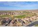 Stunning aerial view of houses near a golf course, offering a picturesque neighborhood setting at 22491 W Woodlands Ave, Buckeye, AZ 85326