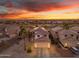 Beautiful aerial view of a well-maintained home featuring solar panels and desert landscaping at sunset at 22491 W Woodlands Ave, Buckeye, AZ 85326