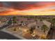 Scenic aerial view of a desert home with solar panels and desert landscaping, near a golf course at 22491 W Woodlands Ave, Buckeye, AZ 85326