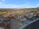 Desert home boasts solar panels, a tile roof, an attached garage, and desert landscaping with palm trees at 22491 W Woodlands Ave, Buckeye, AZ 85326