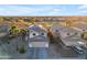 Desert home boasts solar panels, a tile roof, an attached garage, and desert landscaping with palm trees at 22491 W Woodlands Ave, Buckeye, AZ 85326