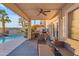 Covered outdoor living space with a built-in grill and access to the pool area at 22491 W Woodlands Ave, Buckeye, AZ 85326