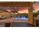 Covered patio and pool featuring pavers, waterfall, and lounge seating at 22491 W Woodlands Ave, Buckeye, AZ 85326