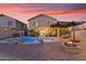Beautiful backyard with pool, fire pit, and plenty of patio space for entertaining at 22491 W Woodlands Ave, Buckeye, AZ 85326