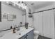 Well-lit bathroom featuring a vanity with framed mirror, shower with curtain, and neutral tones, offering a clean and modern design at 22491 W Woodlands Ave, Buckeye, AZ 85326