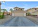 Charming home featuring a spacious three car garage, desert landscaping, and neutral color palette at 22491 W Woodlands Ave, Buckeye, AZ 85326