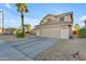 Attractive home features a spacious driveway, desert landscaping, and a neutral color palette at 22491 W Woodlands Ave, Buckeye, AZ 85326