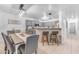 Open-concept kitchen with a breakfast bar and modern lighting at 22491 W Woodlands Ave, Buckeye, AZ 85326