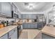 Well-lit kitchen featuring stainless steel appliances and ample cabinetry at 22491 W Woodlands Ave, Buckeye, AZ 85326