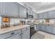 Bright kitchen featuring gray cabinetry and neutral countertops at 22491 W Woodlands Ave, Buckeye, AZ 85326