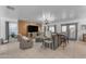 Cozy living room with a comfortable recliner, gray seating, and a stylish decor with natural light at 22491 W Woodlands Ave, Buckeye, AZ 85326