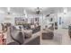 Spacious open-concept living room with modern decor, connecting seamlessly to the kitchen and dining area at 22491 W Woodlands Ave, Buckeye, AZ 85326