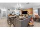 Bright living room featuring modern gray furniture and a stylish wood accent wall with a large TV at 22491 W Woodlands Ave, Buckeye, AZ 85326