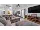 Comfortable living room area with a large sectional sofa, modern lighting, and entertainment setup, ideal for relaxing and entertaining at 22491 W Woodlands Ave, Buckeye, AZ 85326