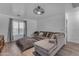 Spacious living room area with a large sectional sofa, modern lighting, and a cozy rug, perfect for relaxation and entertaining at 22491 W Woodlands Ave, Buckeye, AZ 85326