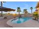 Sparkling pool with lush landscaping and a relaxing water feature at 22491 W Woodlands Ave, Buckeye, AZ 85326