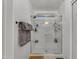 Modern walk-in shower with sliding glass door and built-in shelving for toiletries and soaps at 22491 W Woodlands Ave, Buckeye, AZ 85326